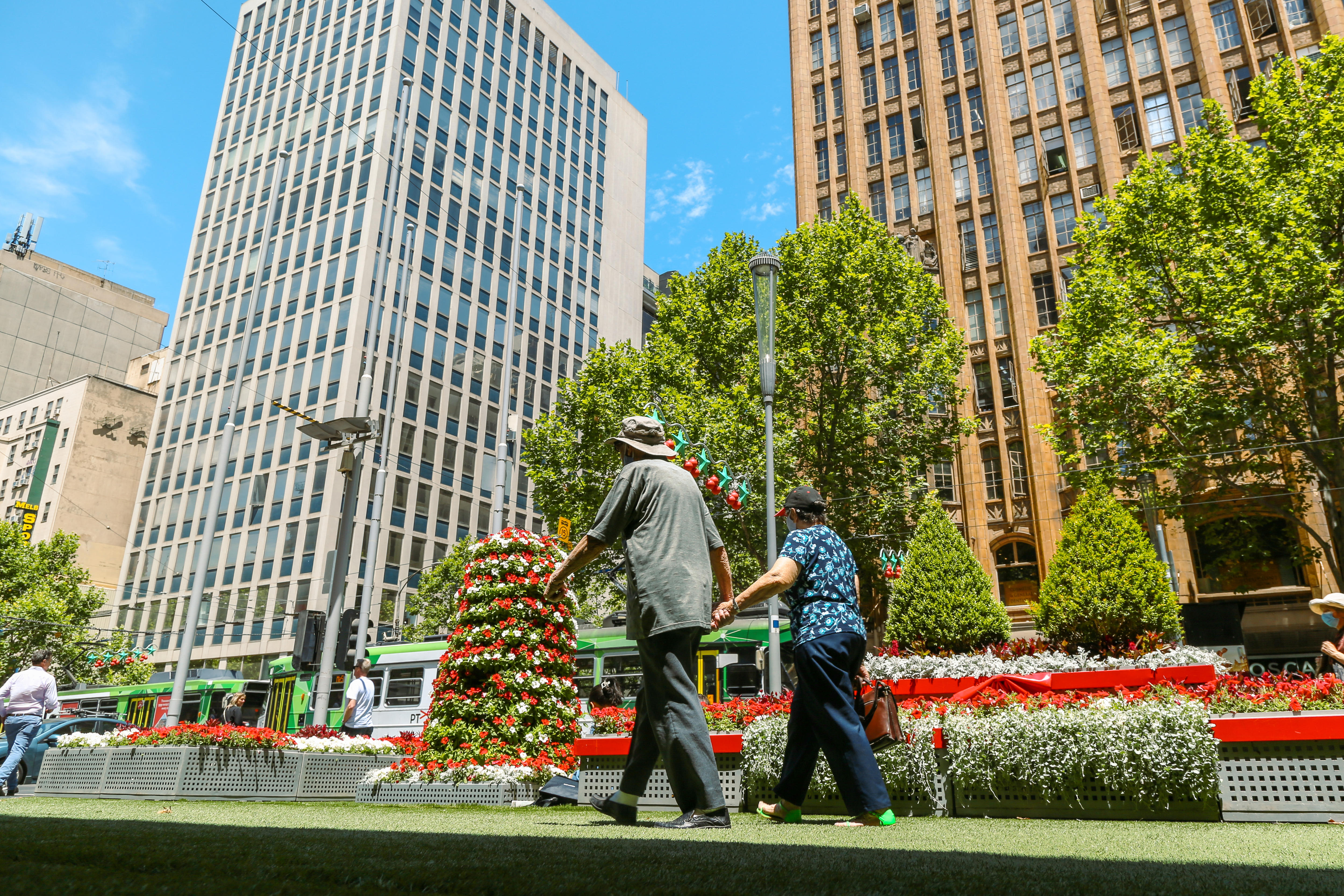 A couple walking in Melbourne's CBD.